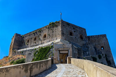 Low angle view of historical building against blue sky