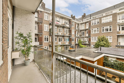 Footpath amidst buildings in city