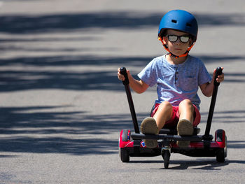 Cute boy riding toy car