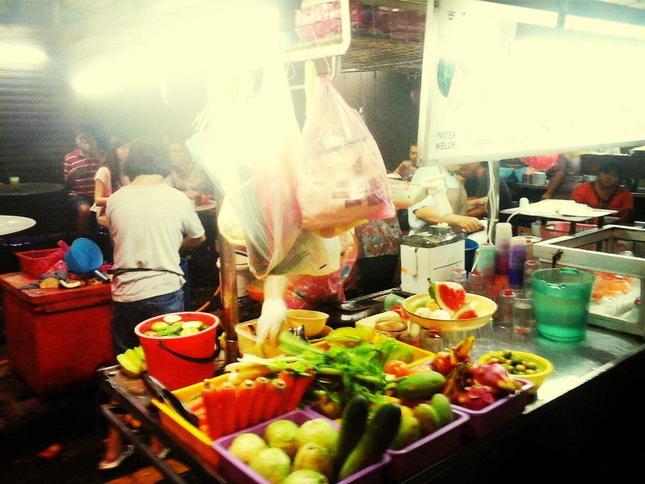 food and drink, food, freshness, healthy eating, indoors, retail, for sale, market stall, market, men, lifestyles, incidental people, choice, variation, small business, vegetable, person, preparation