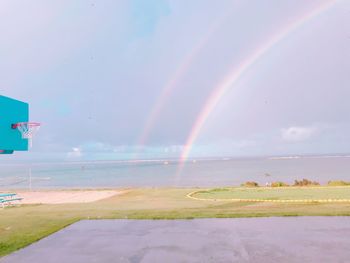 Rainbow over landscape against sky