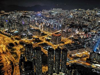 High angle view of illuminated modern buildings in city at night