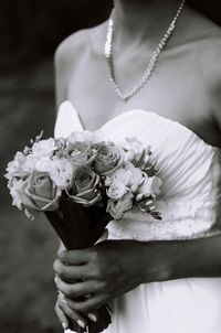 Midsection of bride holding bouquet during wedding ceremony