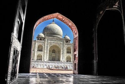Taj mahal seen through archway