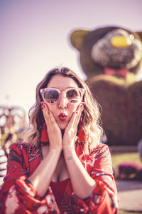 Close-up of woman puckering against teddy bear