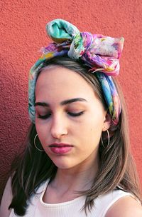 Portrait of beautiful woman against wall