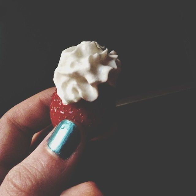 person, holding, part of, human finger, cropped, unrecognizable person, close-up, food and drink, personal perspective, indoors, freshness, sweet food, studio shot, black background, food, ice cream, indulgence