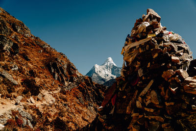 Low angle view of snowcapped mountains against clear sky