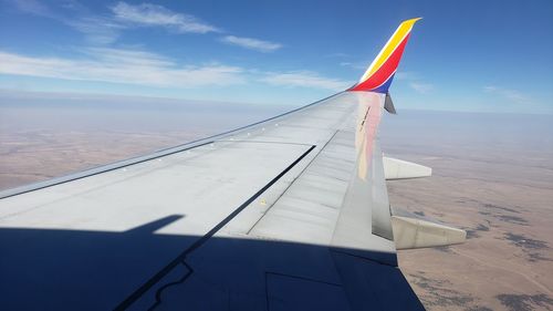 Airplane flying over sea against sky