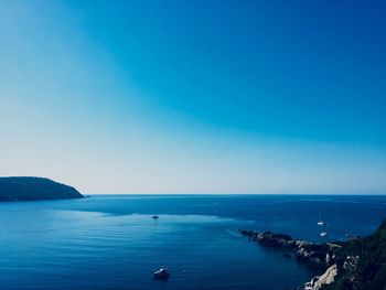 Scenic view of sea against clear blue sky