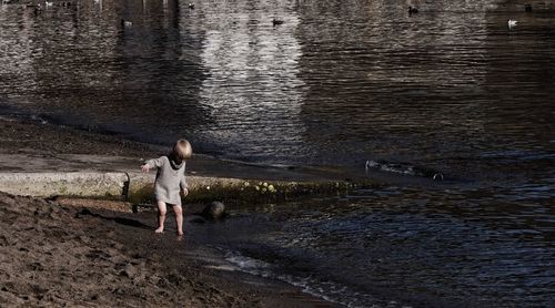 Rear view of woman walking on beach