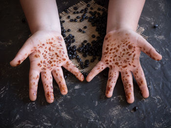 Close-up of boy holding roasted coffee beans