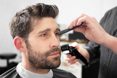 Close-up of young man using mobile phone