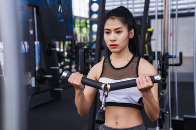 Young woman exercising in gym