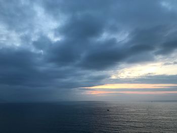 Scenic view of sea against storm clouds