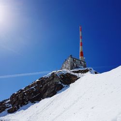 Snow covered mountain against clear blue sky