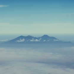 Scenic view of mountains against blue sky