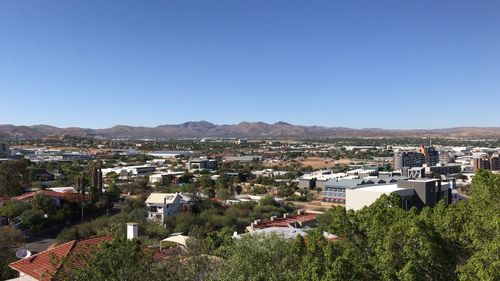 High angle shot of townscape against clear blue sky