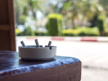 Close-up of coffee on table against wall