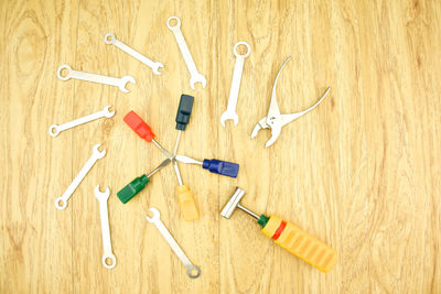 High angle view of various work tools on wooden table