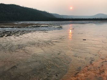 Scenic view of lake against sky during sunset