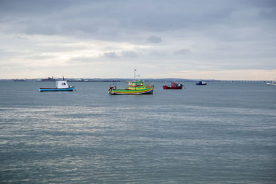 Ship sailing on sea against sky