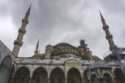 Low angle view of historic building against cloudy sky