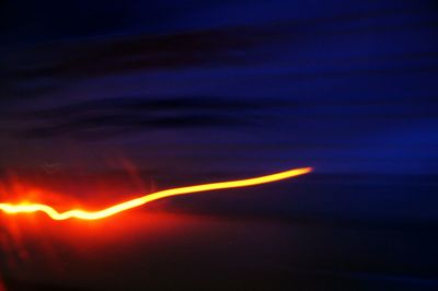 Close-up of vapor trails in sky at night