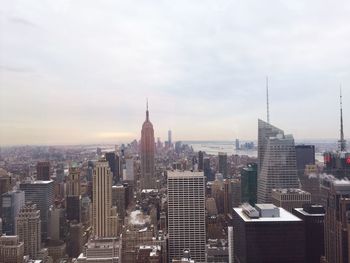 High angle view of cityscape against cloudy sky