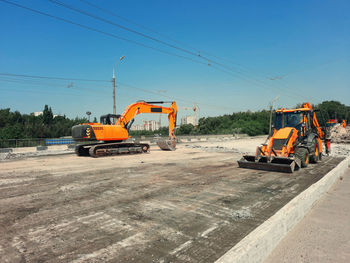 Excavator repairs road, road works