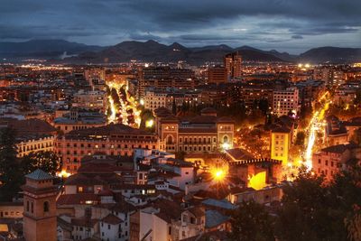 High angle view of city lit up at night