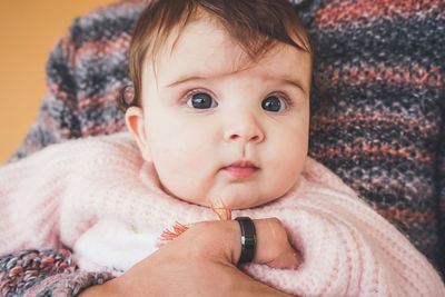 Portrait of cute baby lying down on bed