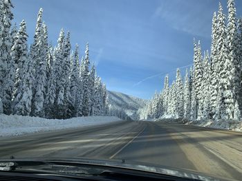 Road seen through car windshield during winter