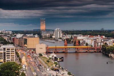 High angle view of river amidst buildings in city against sky