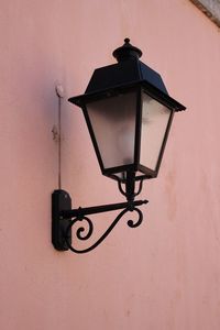 Low angle view of lighting equipment mounted on wall