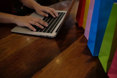 High angle view of woman using laptop on table