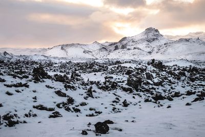 Scenic view of snowcapped mountains against sky during sunset