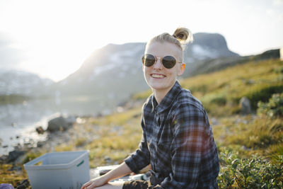 Smiling woman at lake looking at camera