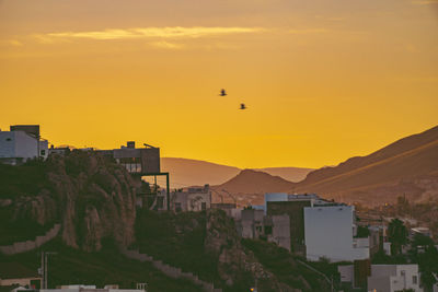 Scenic view of buildings against sky during sunset