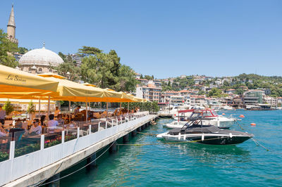 Boats in river with buildings in background