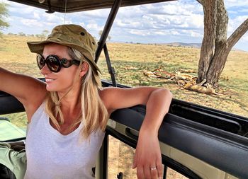 Woman sitting in safari vehicle at national park