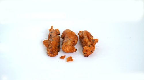 Close-up of cake on plate against white background