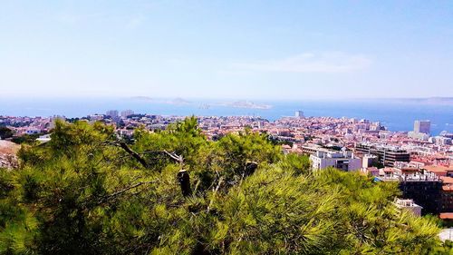 Scenic view of sea with cityscape in background