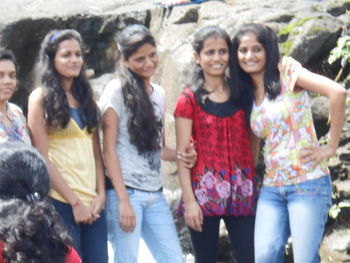 Portrait of smiling young women standing outdoors