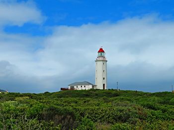 Lighthouse against cloudy sky