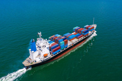 Containers ship import and export international businesses services by the sea aerial view 