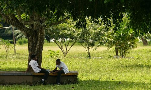 Man sitting on bench in park