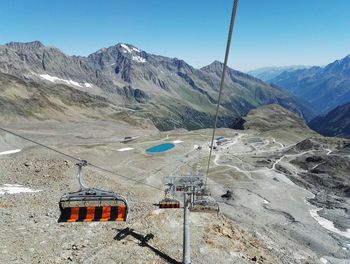 High angle view of ski lift against mountains on sunny day