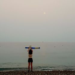 Rear view of man standing on beach