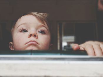 Portrait of cute boy using mobile phone at home